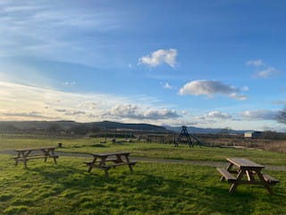 Our rustic play area with picnic benches is fun for everyone